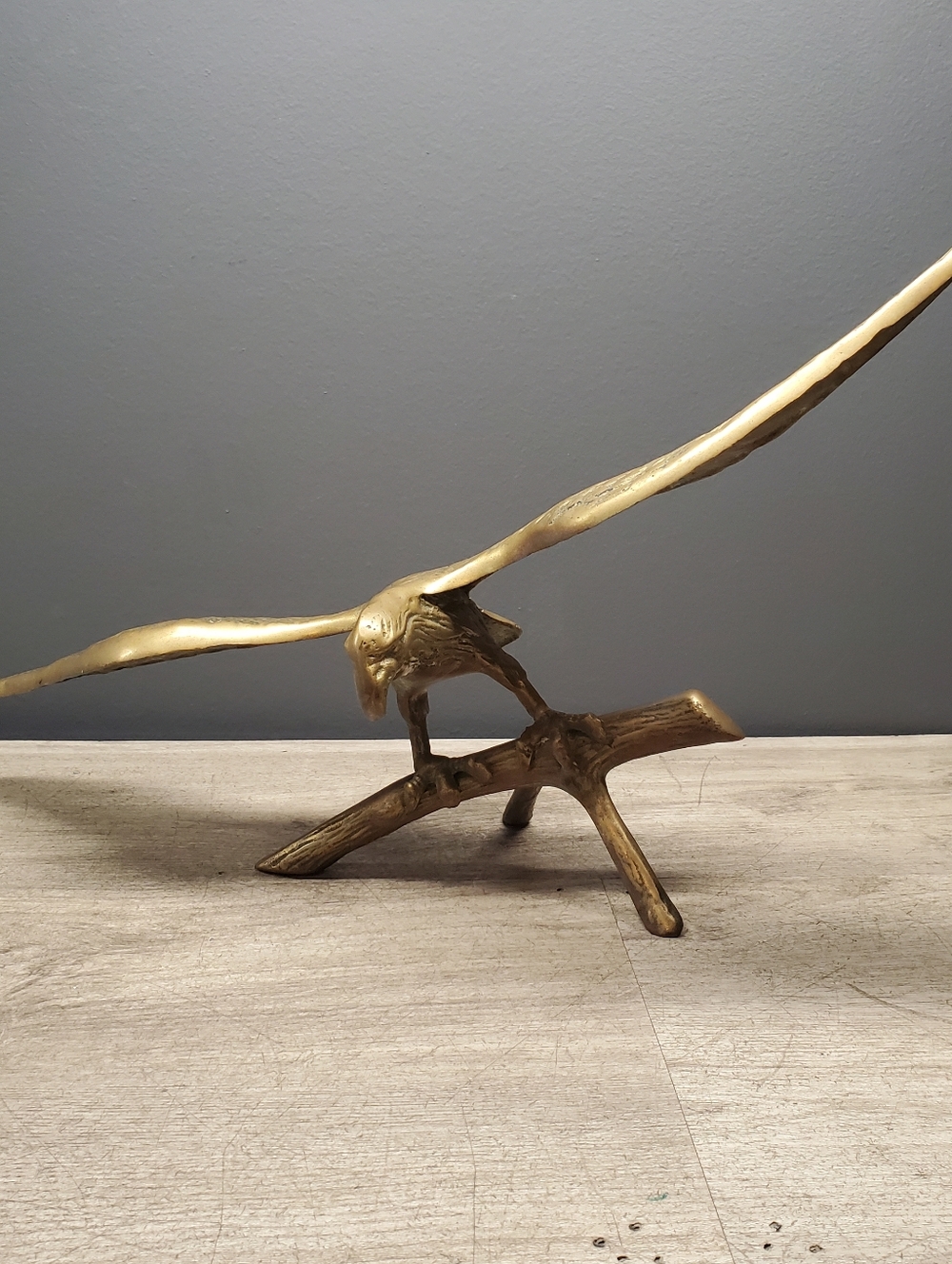 Vintage solid brass eagle figurine perched on a branch
